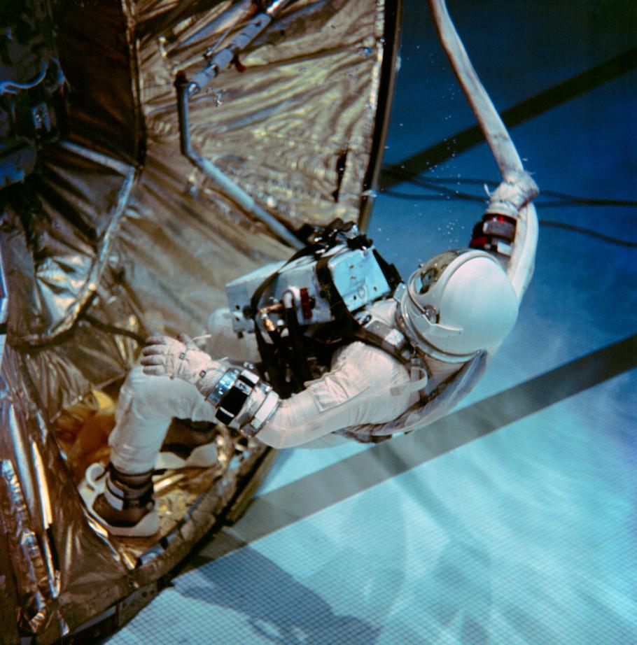 Astronaut wearing spacesuit underwater in a pool