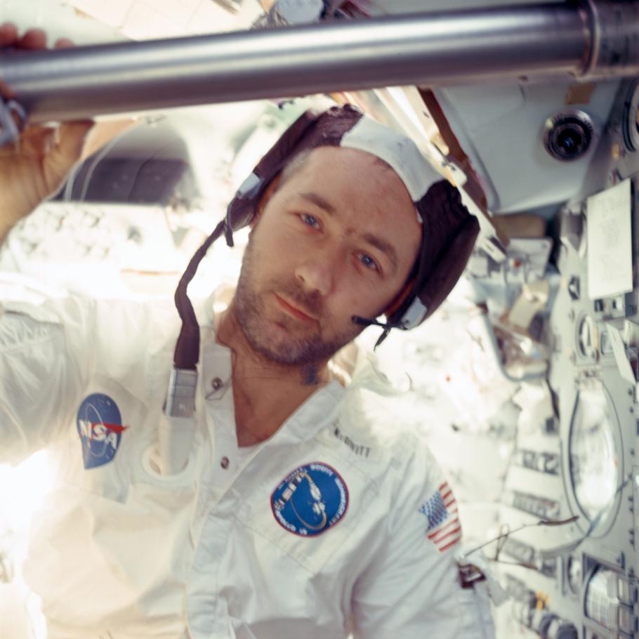 A picture of James McDivitt in space inside of a spacecraft and looking directly at the camera