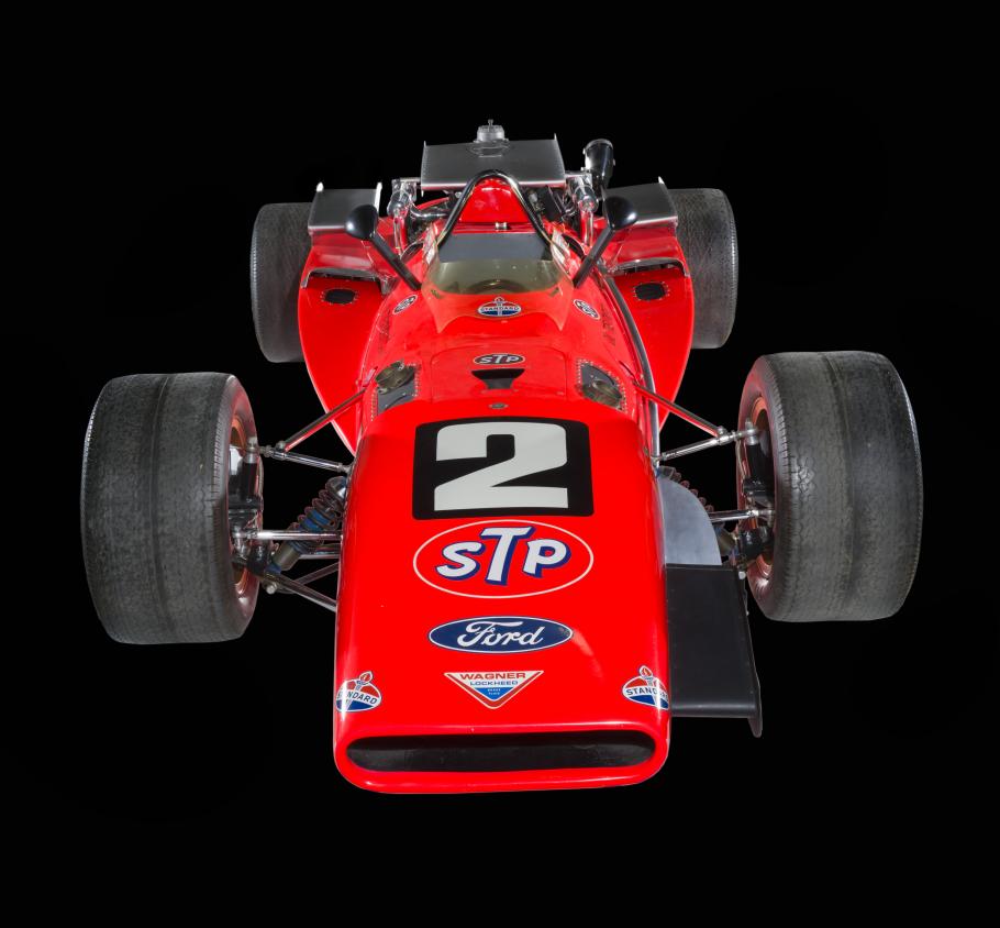 Red race car with the number 2 on the front, photographed against a black background.