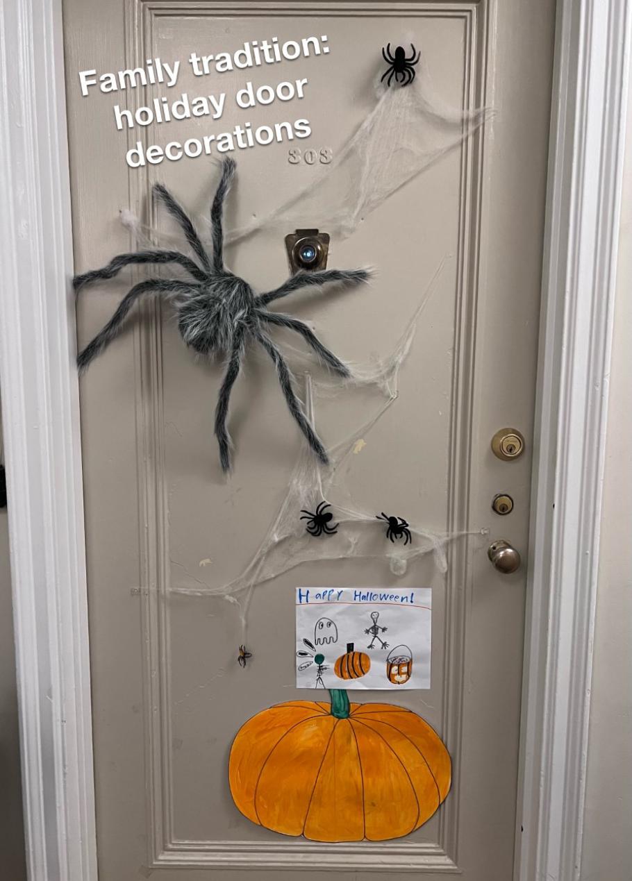 A door with spooky decorations including spiders and cobwebs. Text on the image reads "Family tradition: holiday door decorations."