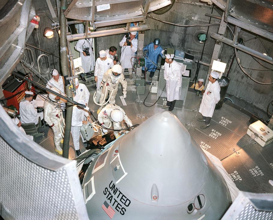 The command module juts up through the floor at the center of the altitude chamber at the Kennedy Space Center—where the three Apollo 1 astronauts prepare to enter for their first manned test of the spacecraft.