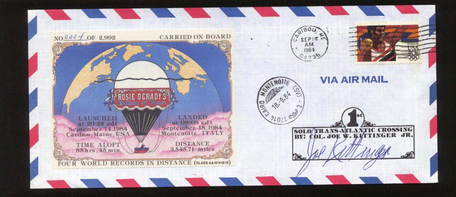 A mail envelope with a USA stamp on it and a postcard with an air balloon attached to it.