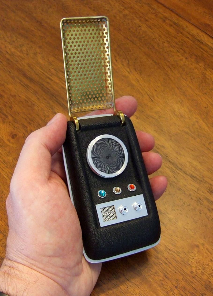 A small black device with a swirly screen, and three buttons. 