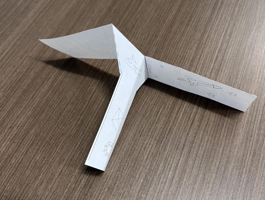 A paper whirligig made by folding a piece of 