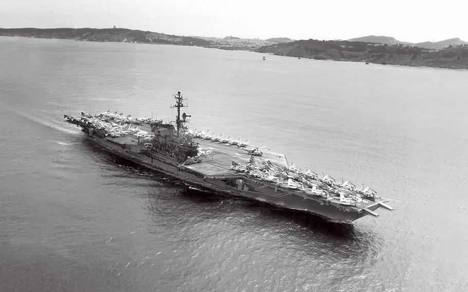 The U.S. Navy aircraft carrier USS Midway, its deck packed with aircraft, departs San Francisco Bay in April 1972.