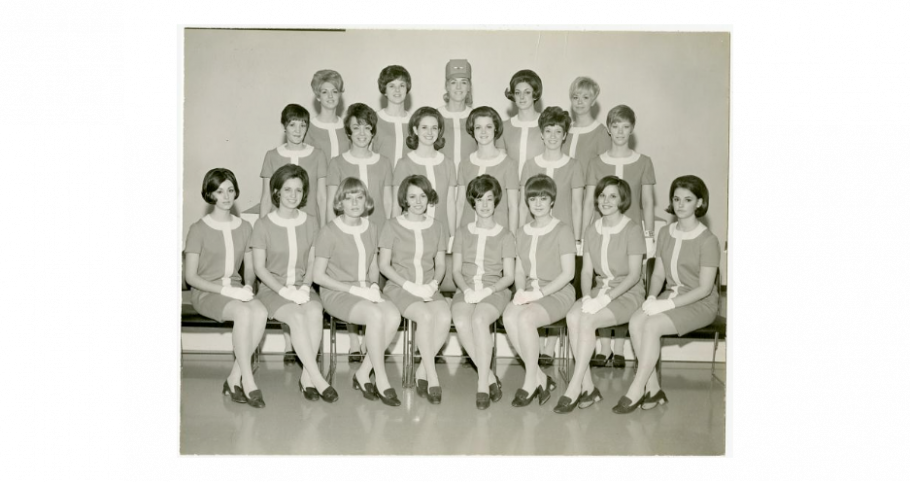 A group of flight attendants pose for a picture.