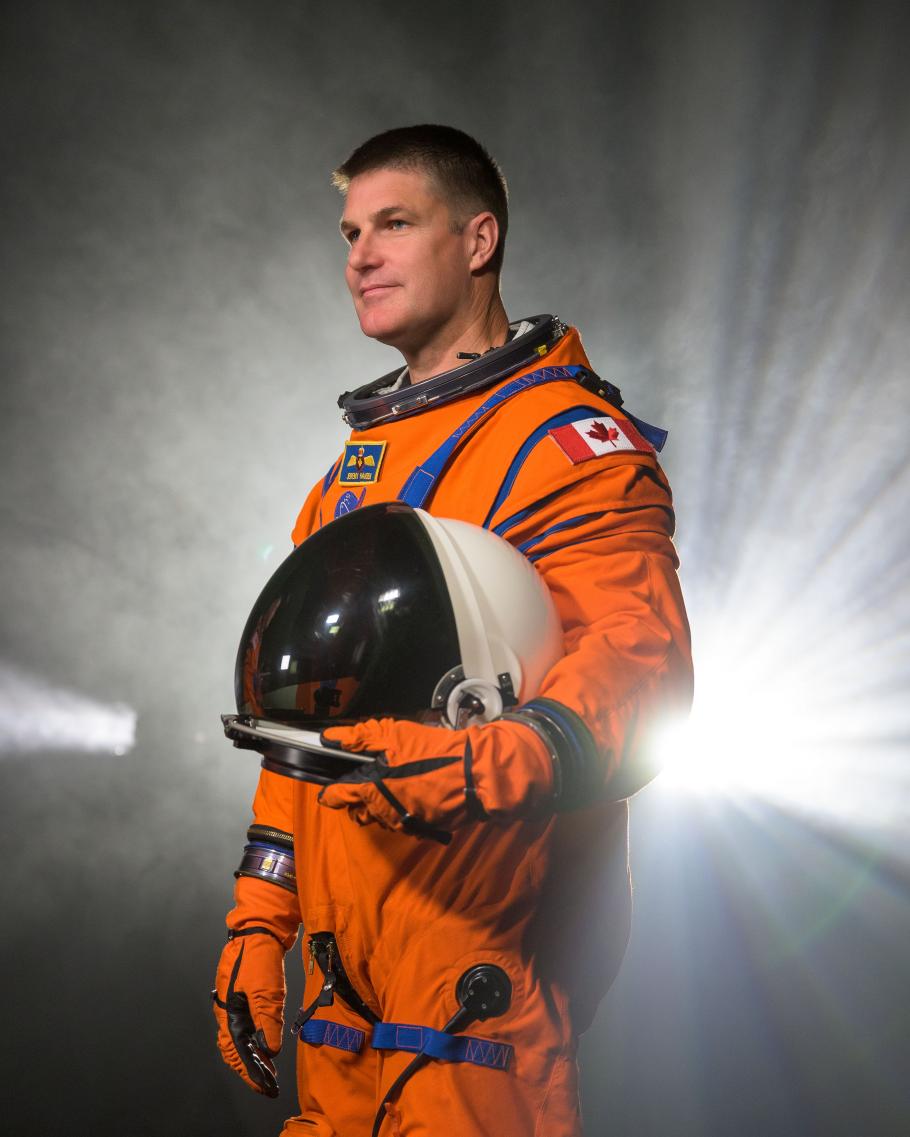 Jeremy Hansen wearing an orange Artemis flight suit