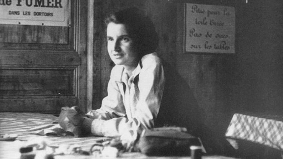 Rosalind Franklin sits at a table
