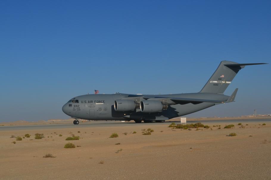 C-17 Globemaster aircraft on a desert airfield.