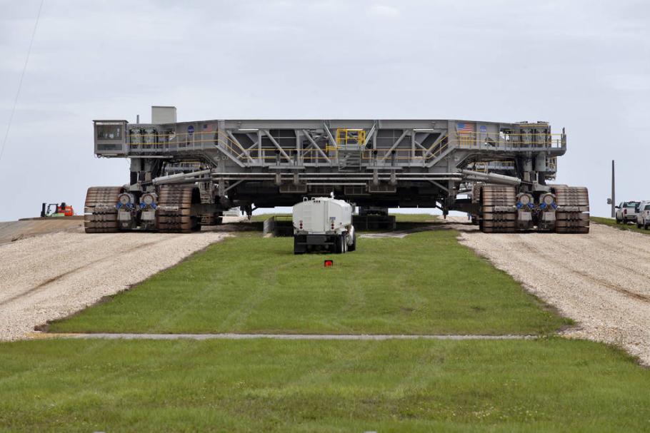 Giant mobile launch crawler on roadway.