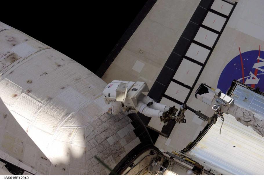 Astronaut working exterior of a Space Shuttle.