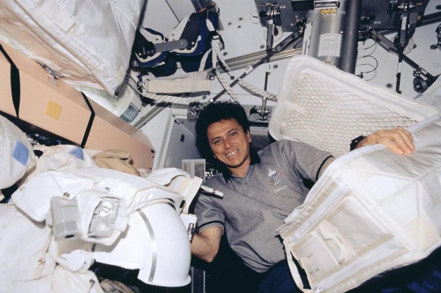 An astronaut floats in zero gravity inside of a space vehicle without a spacesuit.
