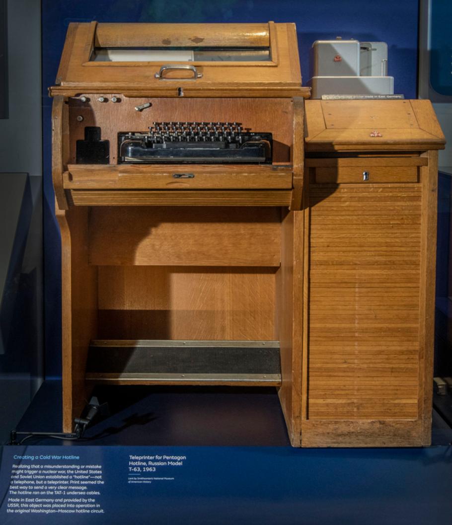 A keyboard sits in a wooden oak cabinet.