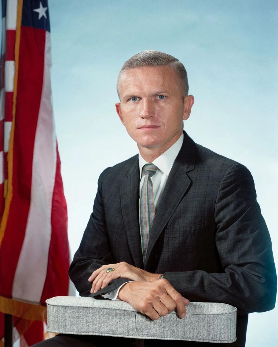 Frank Broman poses for a portrait with the American flag in the background.