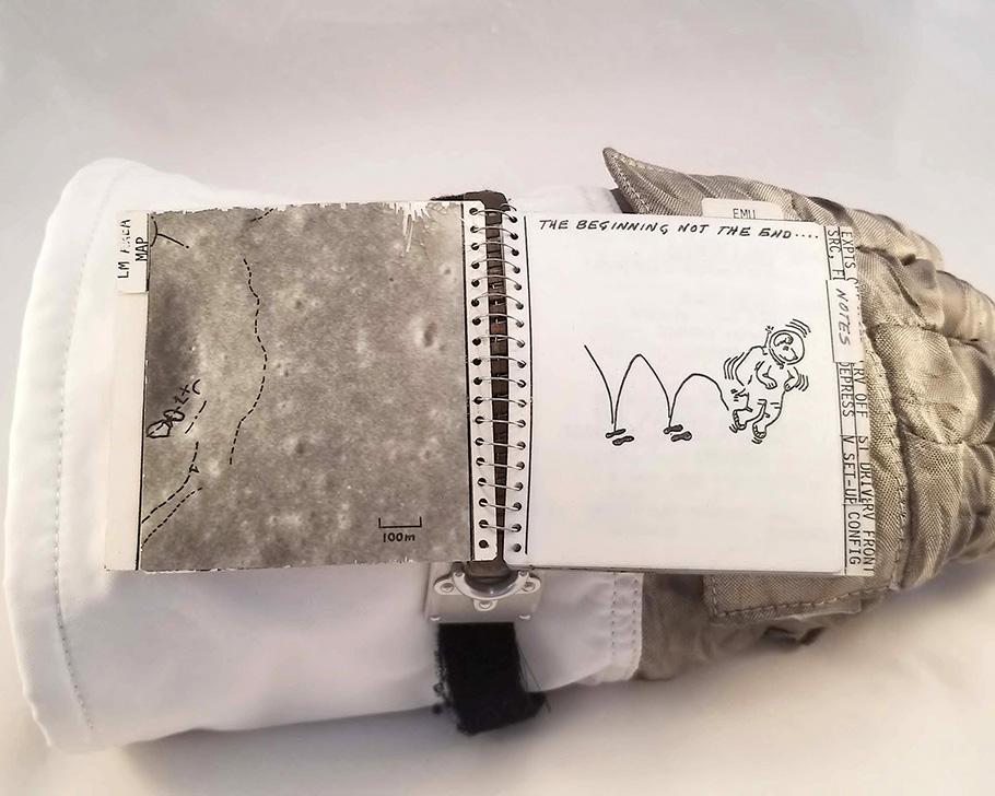 A page of a NASA astronaut checklist features a doodle of a beagle wearing a spacesuit, hopping across the lunar surface. Although it resembles Snoopy, it was actually drawn by a NASA engineer.