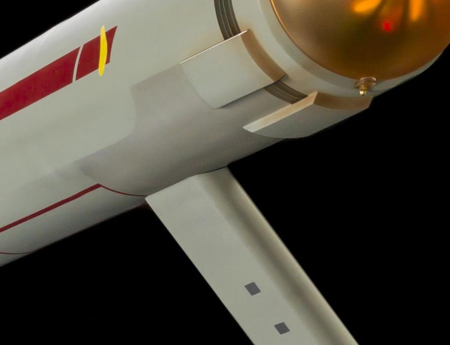 A close up image that shows rectangular shapes on the bottom of an arm that extends from the starship. 
