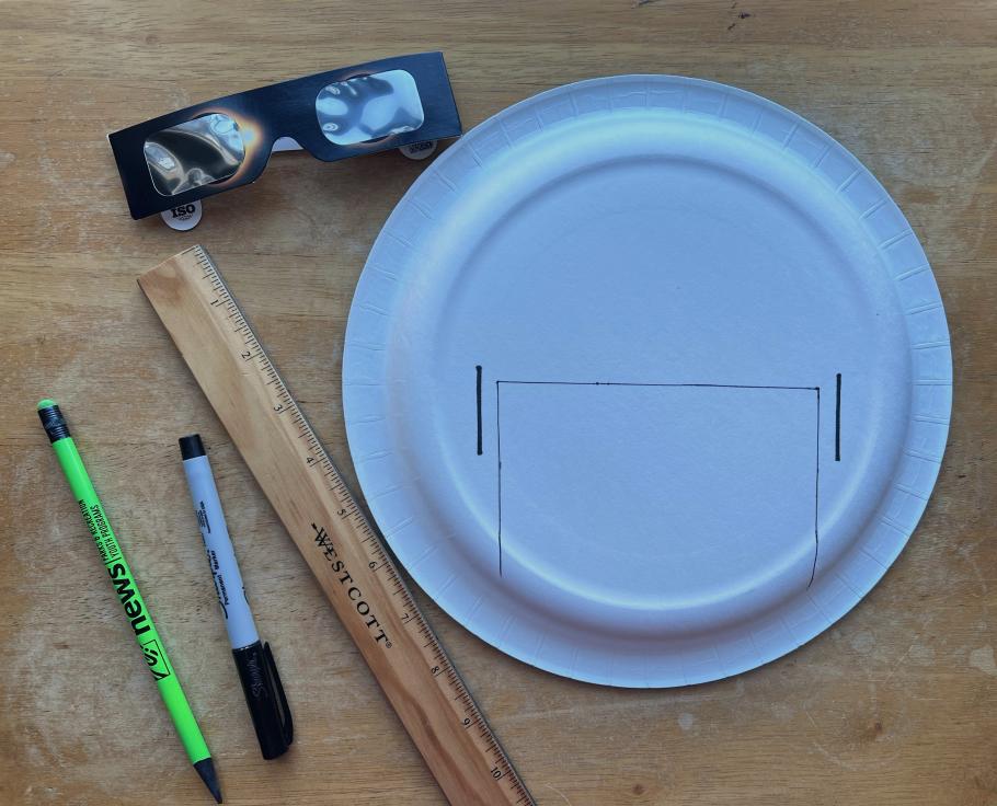 Materials used to create a safe eclipse solar viewer, including glasses, a plate, a rule, pen, and pencil. 