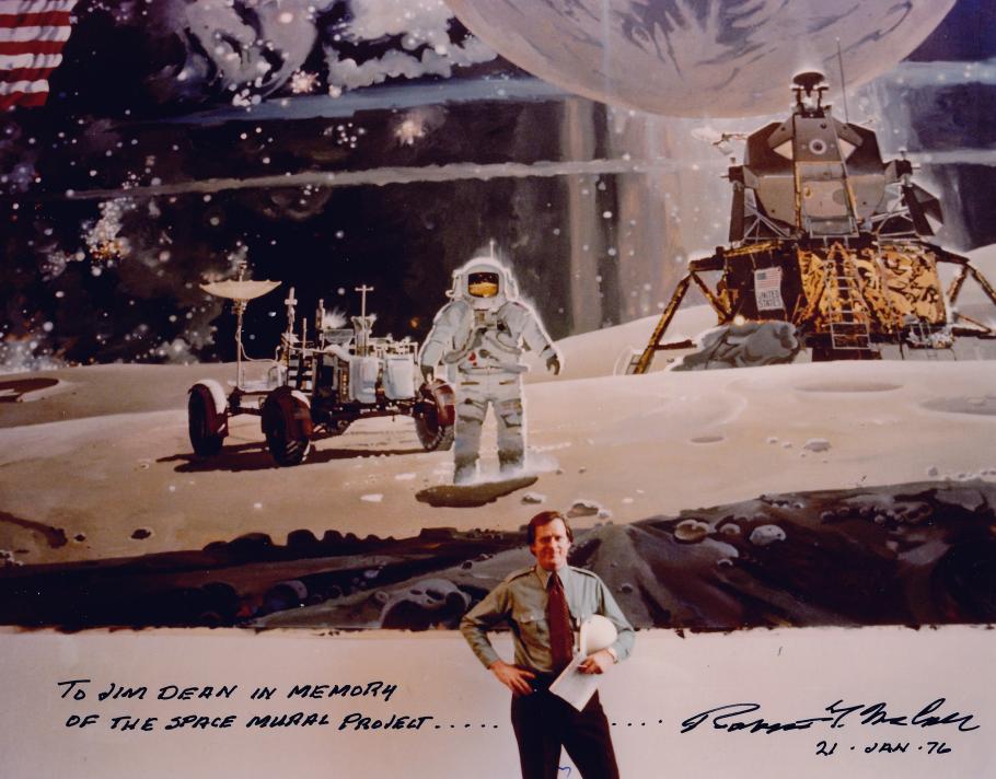 A man standing in front of a large mural artwork of a moon landing scene.