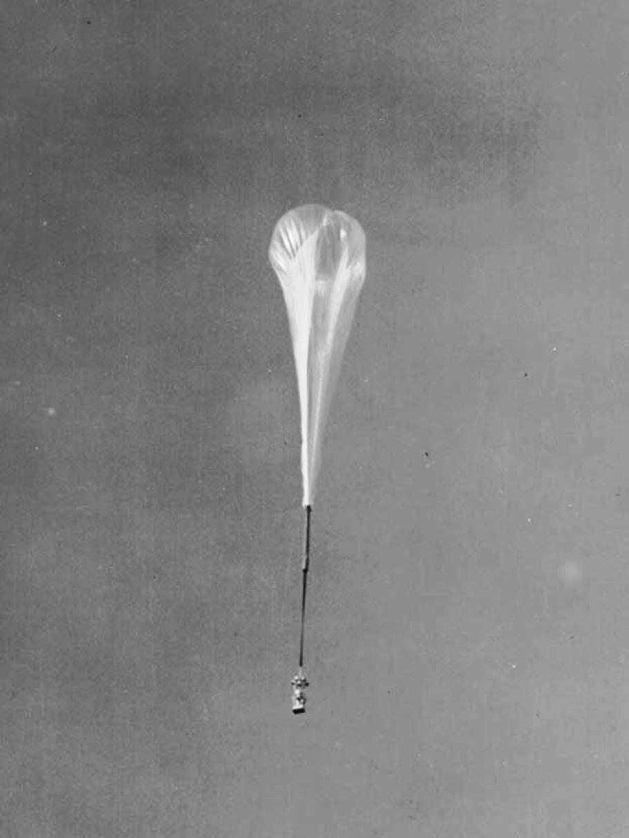 A rocket attached to a hot air balloon.