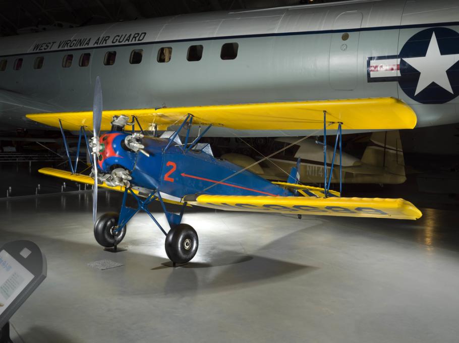 A blue biplane with yellow wings and a silver propeller. The number "2" is painted prominently on the side. 