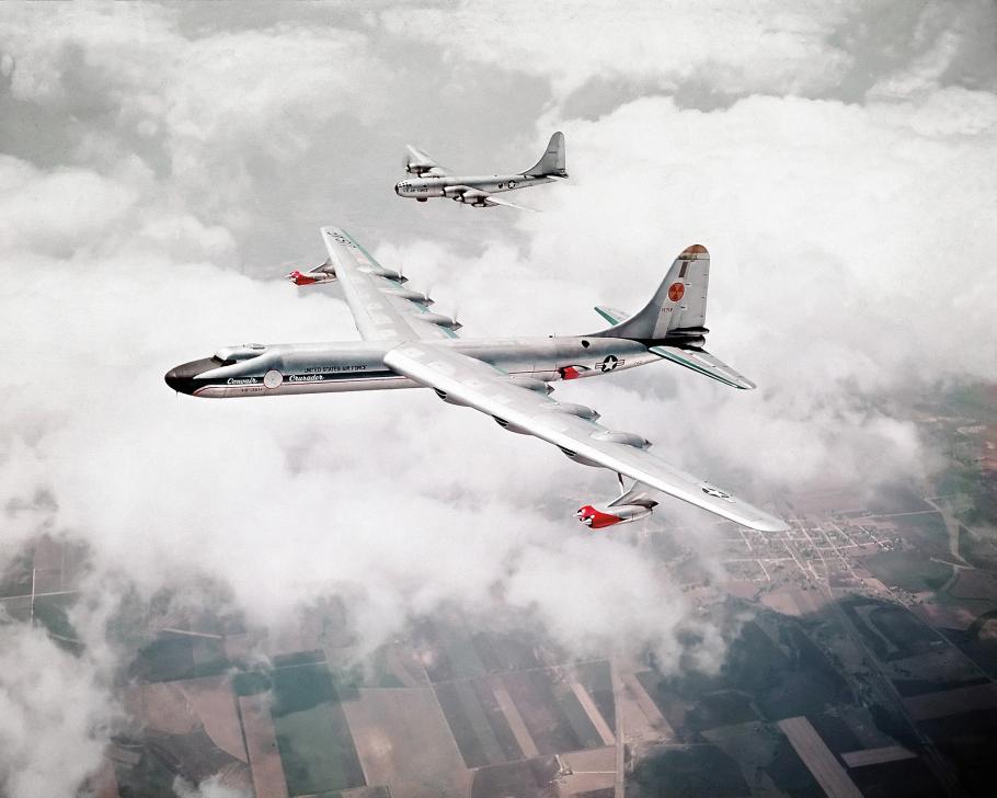 An air-to-air view of the Convair NB-36H and a Boeing B-50 with clouds and fields in the background.