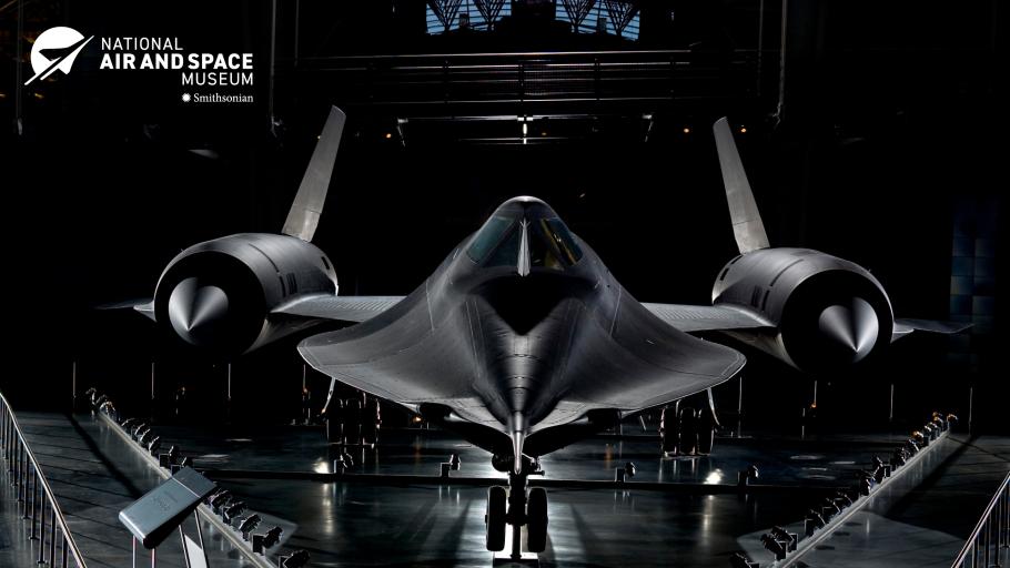 The Blackbird SR-71, a Cold War era spy plane, stands against a black background. The plane is the epitome of cool, all swooping black lines to enable it to fly very very fast. 