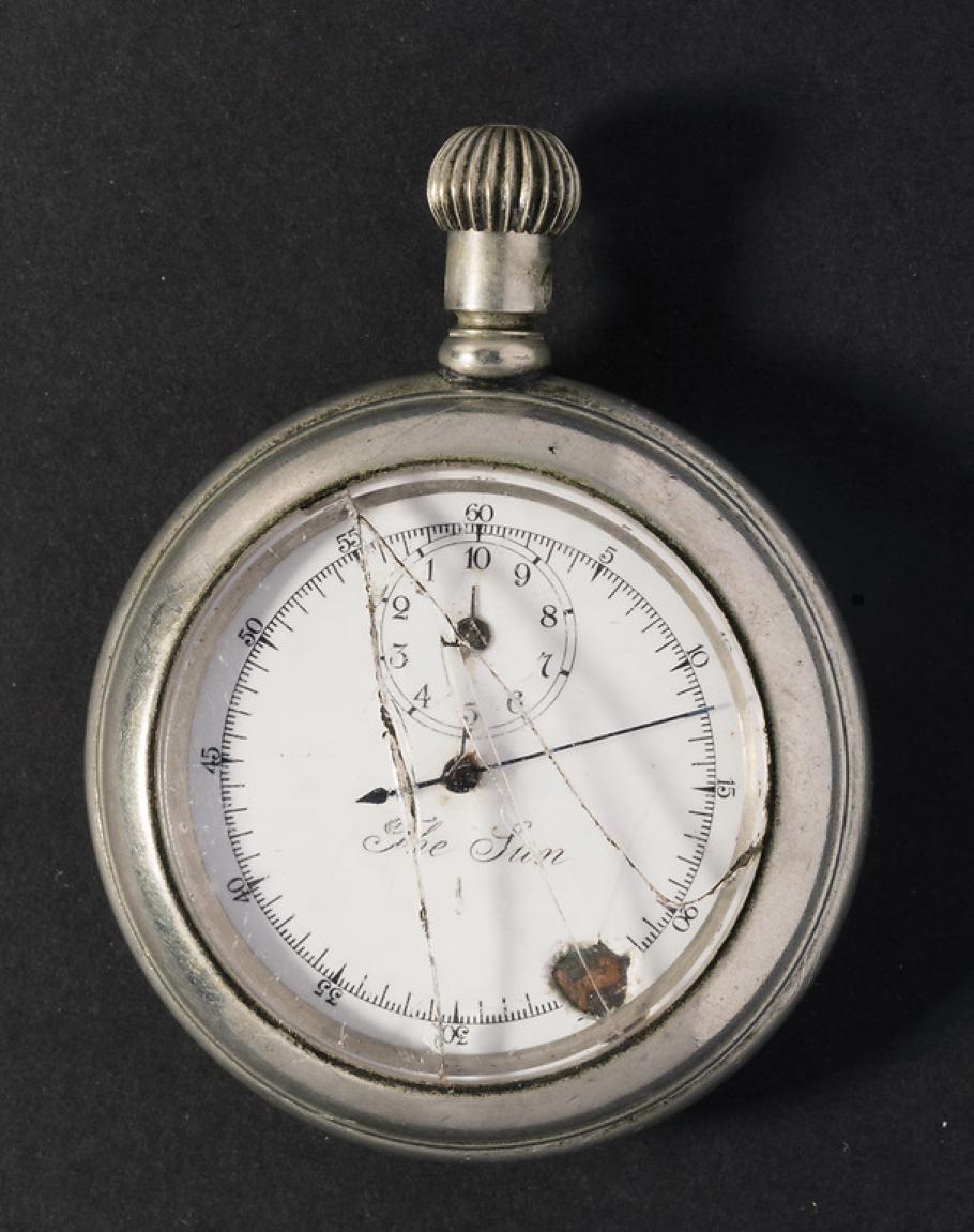 Broken stopwatch with hand pointed at nine-minute mark. 