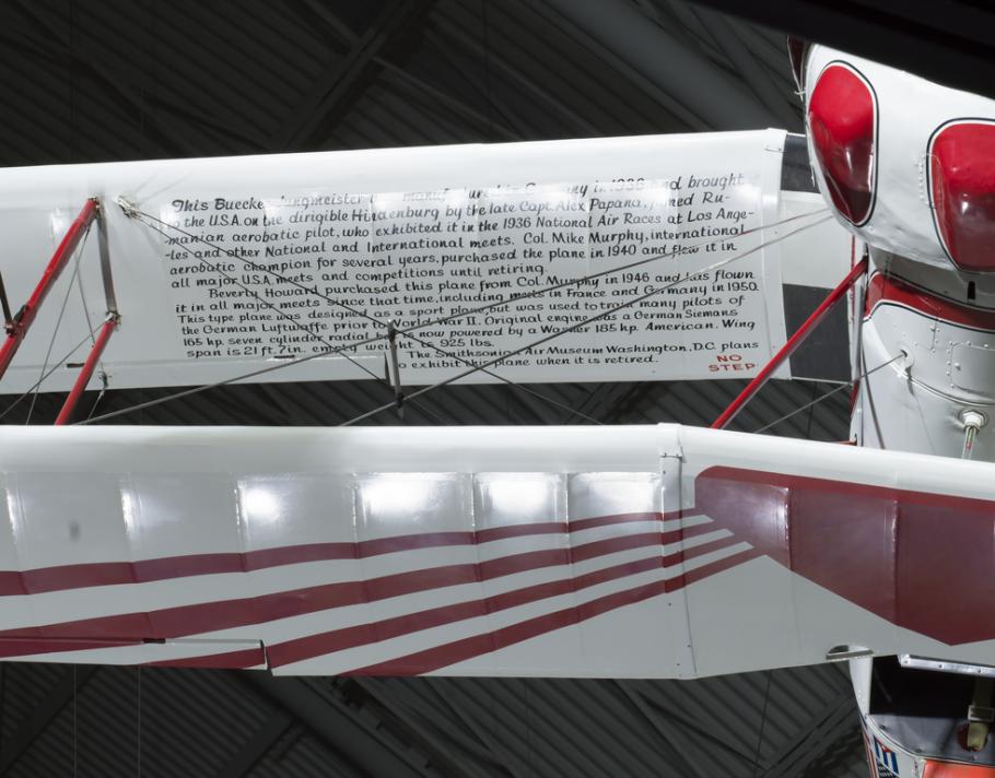 White and red painted wing with black text. 