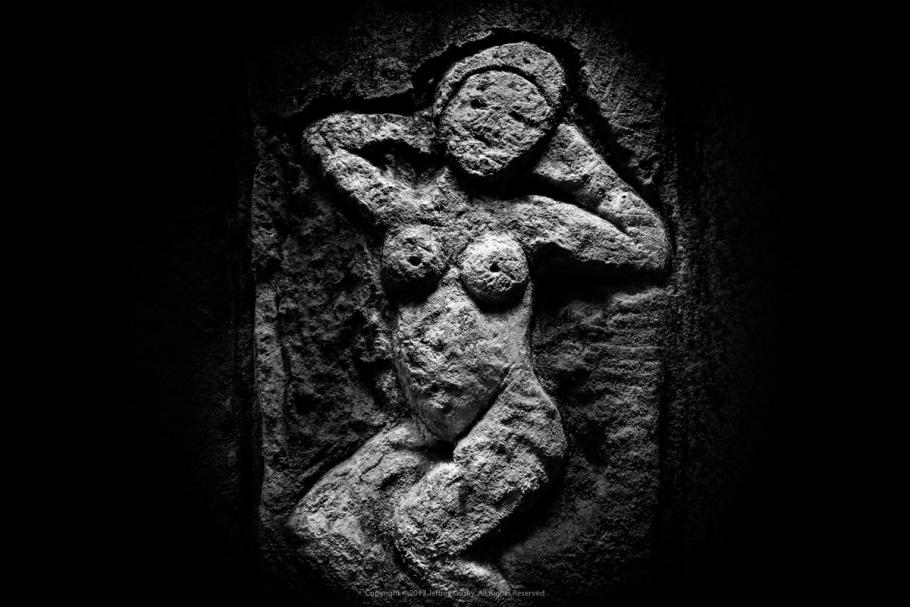 Figure of a woman engraved on stone. 