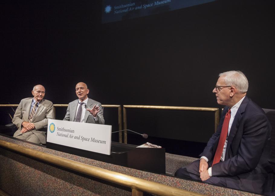 David Rubenstein, chair of the Smithsonian Board of Regents (right), moderates a discussion between Gemini and Apollo Astronaut Michael Collins (left) and Amazon CEO Jeff Bezos (center).