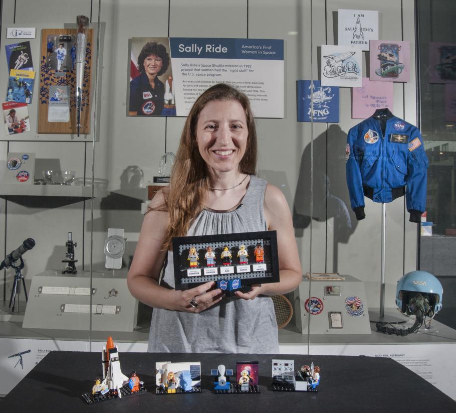 Maia Weinstock with her LEGO® set in front of a Sally Ride display case at the Smithsonian’s National Air and Space Museum in Washington DC.