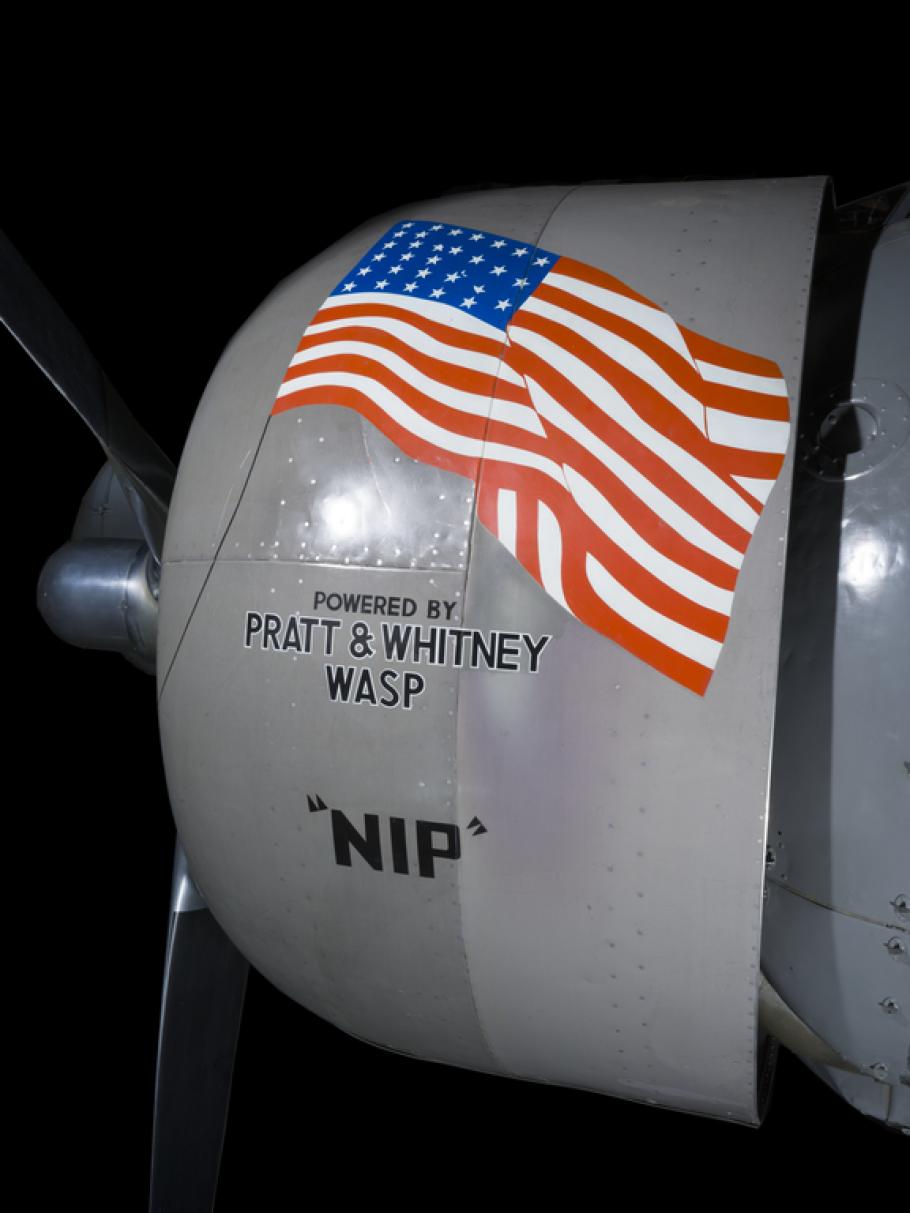 View of an engine with an American flag logo on an airplane. 