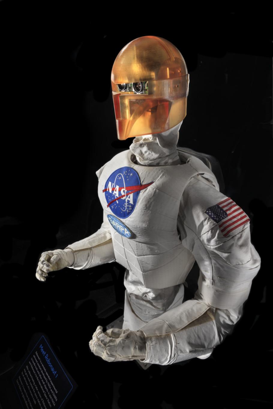 Upper body of a robot with arms, chest with a NASA logo, and an orange face cover.