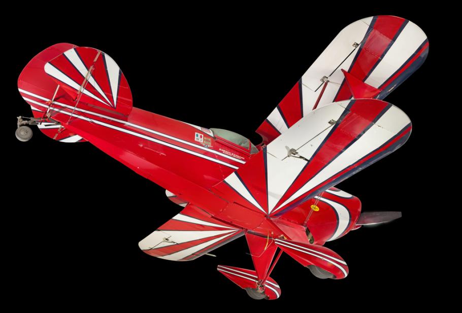 View of the undercarriage of a red, white, and blue painted aerobatic biplane. 