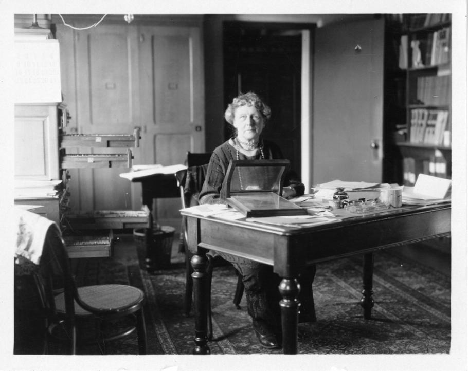 Black and white photo of Cannon at her desk. 