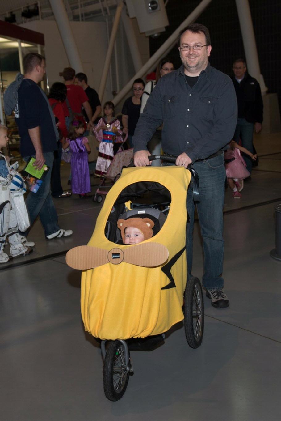 An infant is dressed up in a Piper Cub-inspired Halloween costume during the Museum's annual Halloween event.