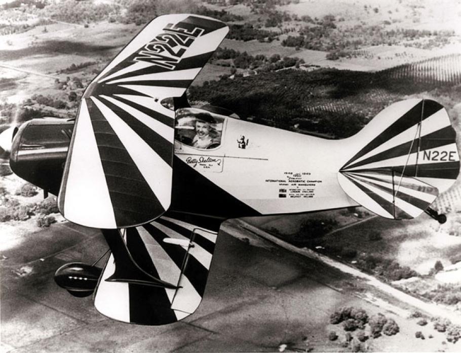A black and white photograph of a plane with striped wings.
