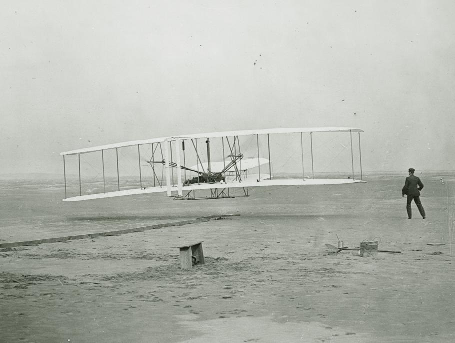 Black and white historic photo of Wright Brothers' first flight
