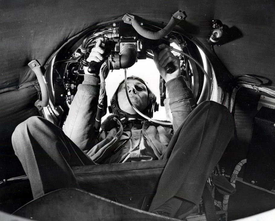 Airmen in gunner's seat in aircraft