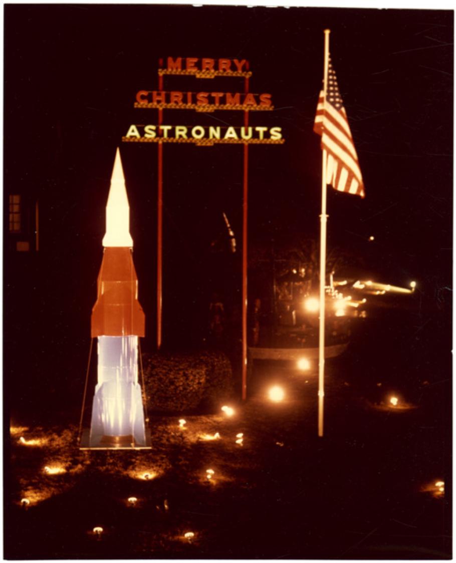 Rocket, flag and sign saying \"Merry Christmas Astronauts\"