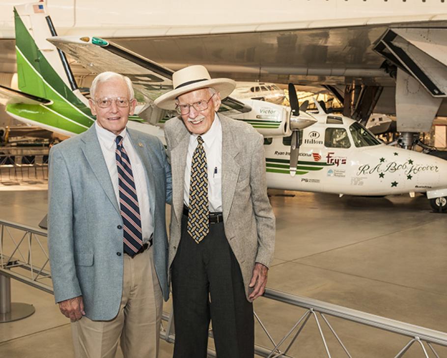 The Museum&#039;s director and famed pilot stand beside Hoover&#039;s green and white Shrike Commander. 