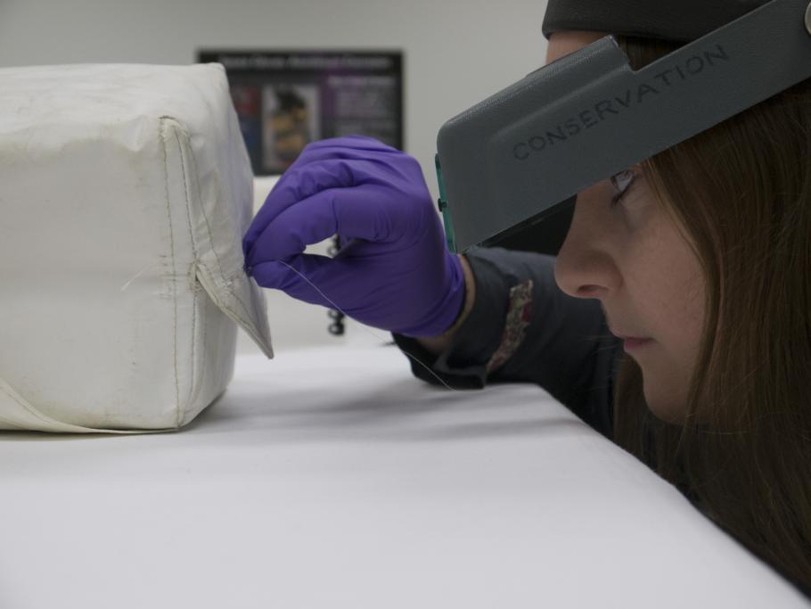 View of the repair being made to the tear in the Beta cloth medical container by Conservation intern&nbsp;Meghann Kozak