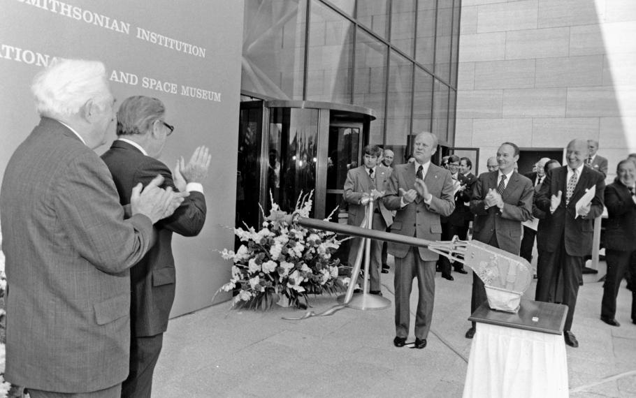 Black and white photo of the ribbon cutting ceremony of the National Air and Space Museum&#039;s building in Washington, DC. 