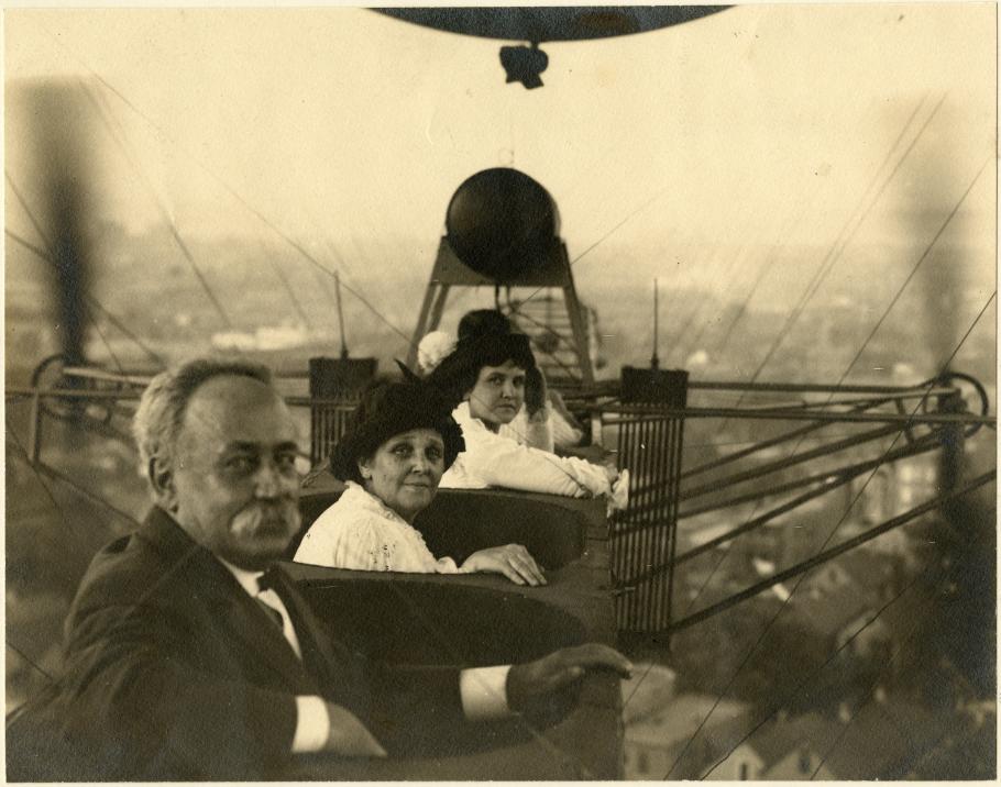 Three people sit in an airship