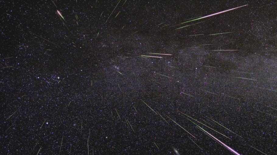 Image of the night sky wiht streaks of colorful meteors.