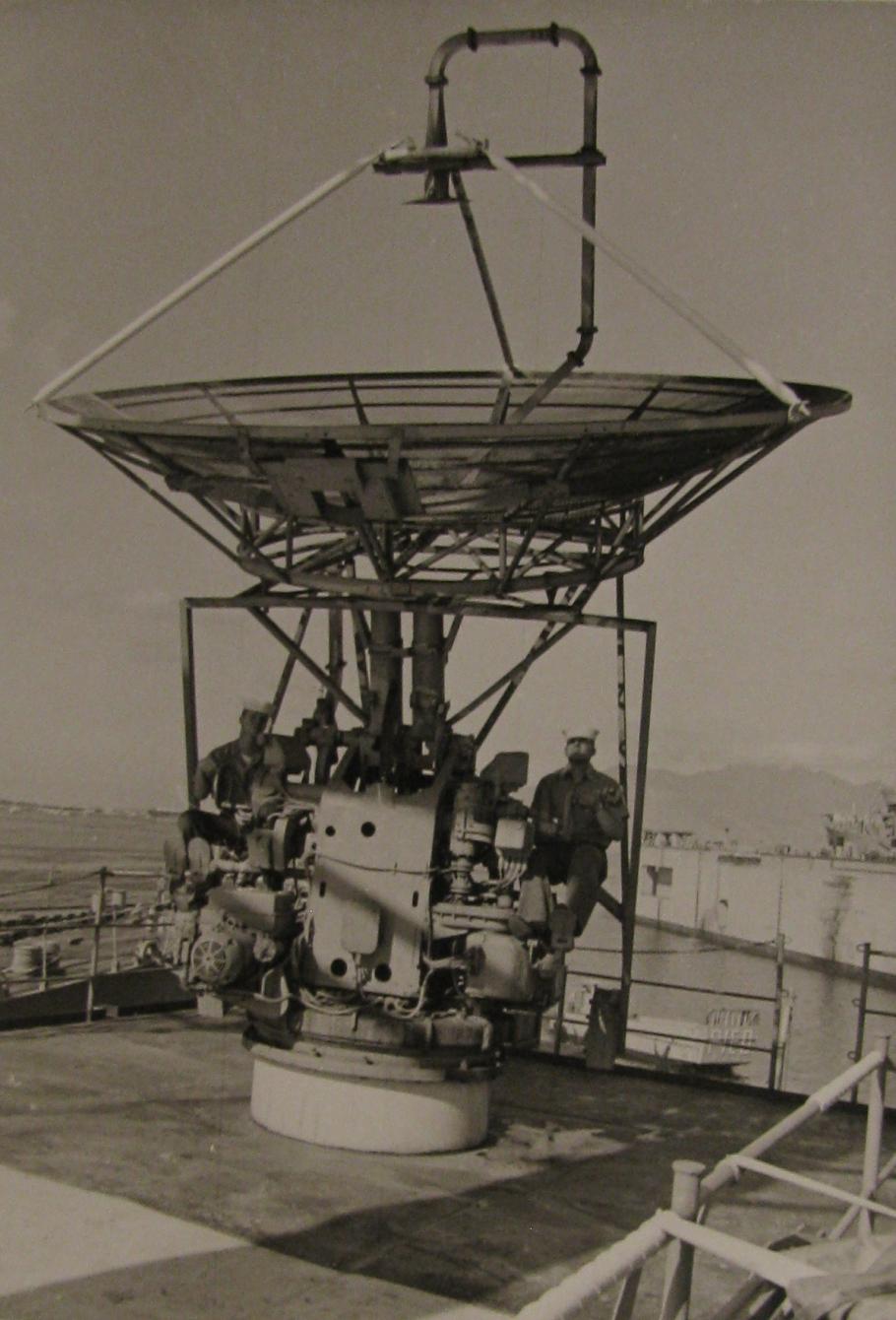 Black and white photo of two technicians installing antenna