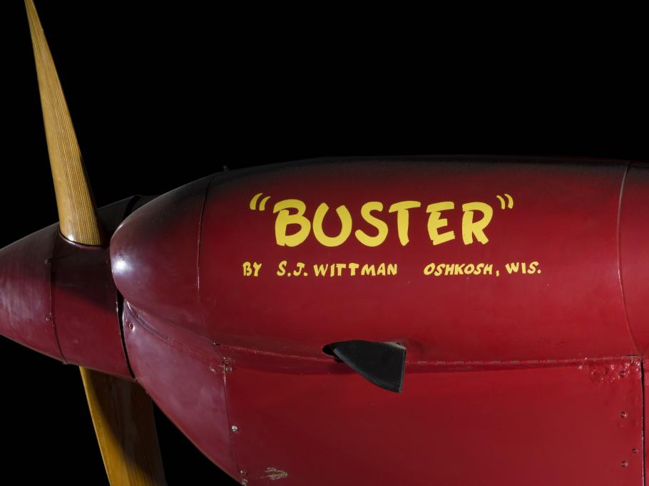 Side of nose of red Wittman Special 20 "Buster" aircraft with ""Buster"" and identification in yellow lettering