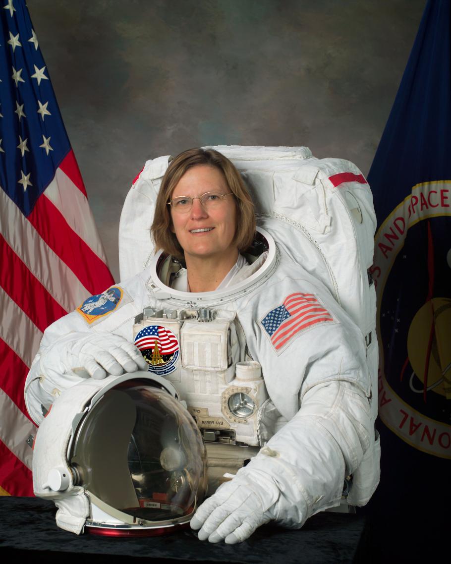 Dr. Kathryn D. Sullivan, a white female astronaut, poses formally in astronaut gear for her official portrait.