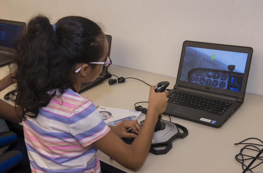A student attending the "She Can" STEM camp flies a Cessna simulator at the Steven F. Udvar-Hazy Center.