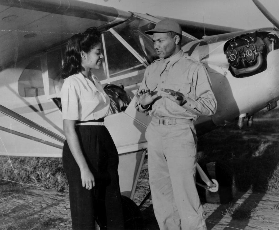 Man and woman in front of an airplane